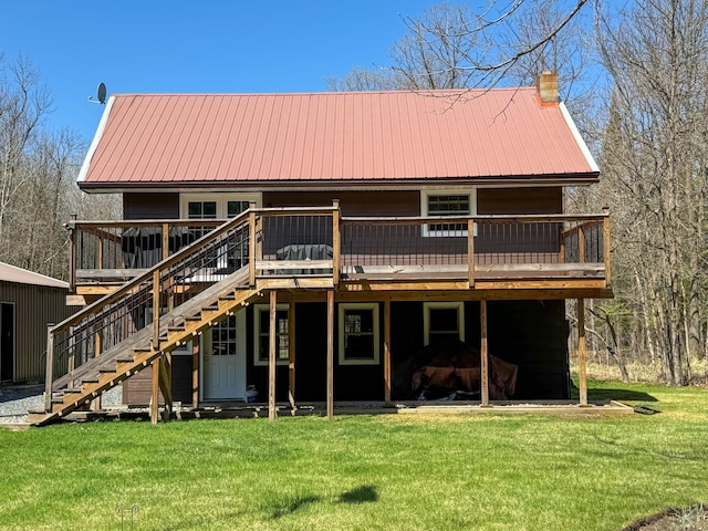 17783 Lookout Tower Rd NE, Hines, MN 56647 - back of house with stairs, a wooden deck, a lawn, and metal roof