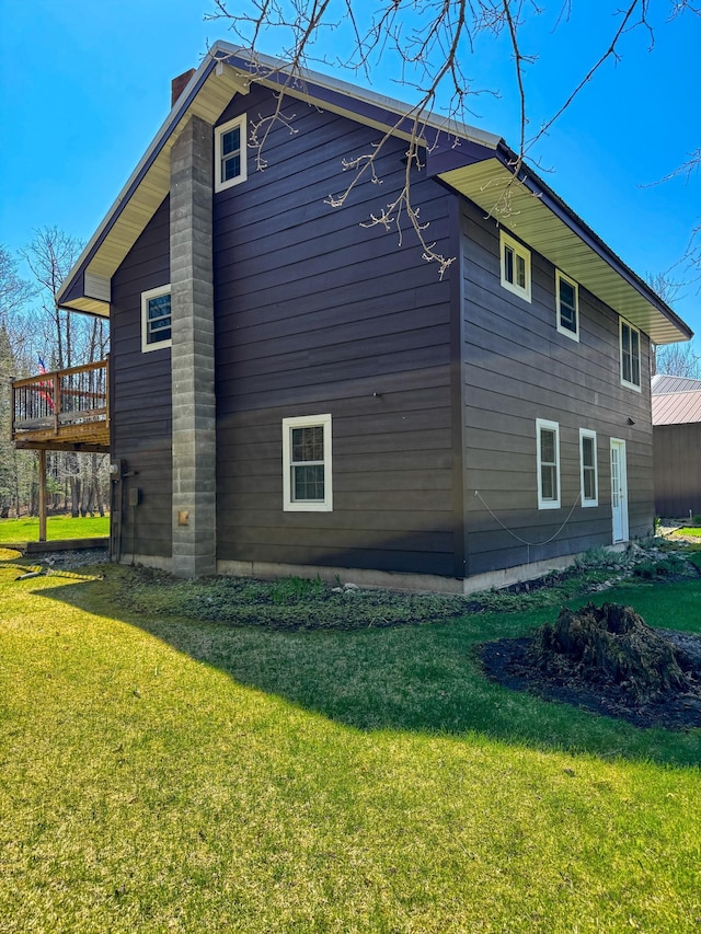 17783 Lookout Tower Rd NE, Hines, MN 56647 - view of side of property with a chimney, a yard, and a wooden deck