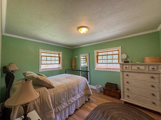 17783 Lookout Tower Rd NE, Hines, MN 56647 - bedroom with crown molding, light wood-style floors, a textured ceiling, and baseboards