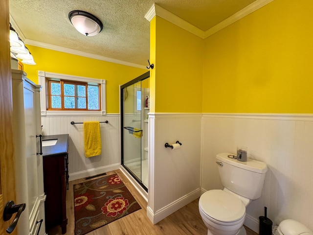 17783 Lookout Tower Rd NE, Hines, MN 56647 - bathroom with wainscoting, toilet, wood finished floors, a shower stall, and vanity