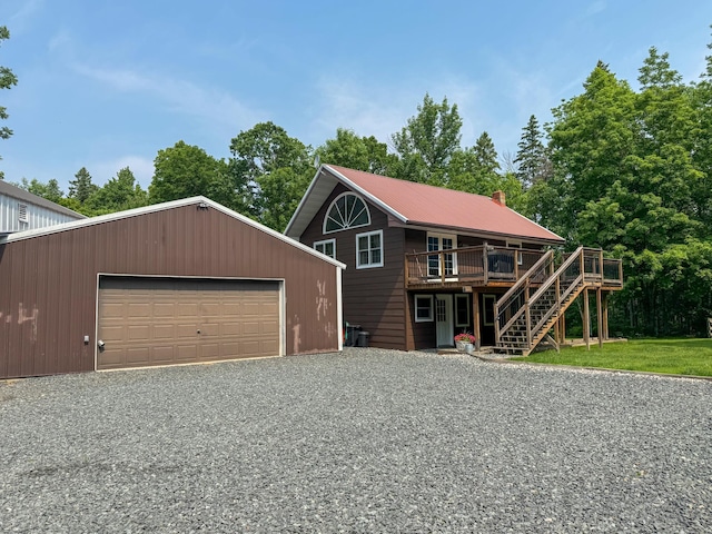 17783 Lookout Tower Rd NE, Hines, MN 56647 - view of front of property with a garage, stairs, a deck, an outbuilding, and a metal roof