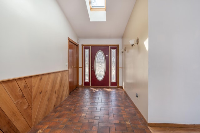 1122 Andrew Dr NE, Lake Andrew Twp, MN 56273 - foyer entrance with a skylight, lofted ceiling, wood walls, and a wainscoted wall