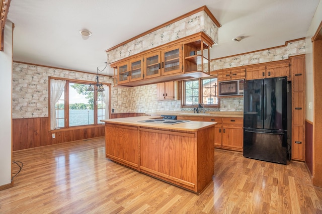 1122 Andrew Dr NE, Lake Andrew Twp, MN 56273 - kitchen featuring freestanding refrigerator, stainless steel microwave, healthy amount of natural light, a center island, and wainscoting
