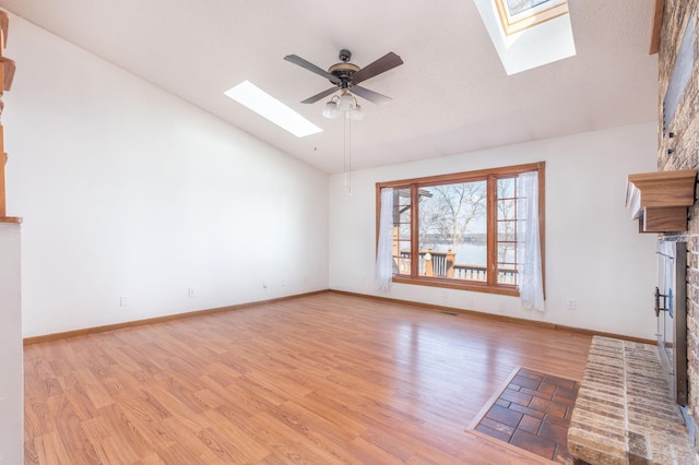 1122 Andrew Dr NE, Lake Andrew Twp, MN 56273 - unfurnished living room with a skylight, ceiling fan, light wood-style floors, high vaulted ceiling, and baseboards