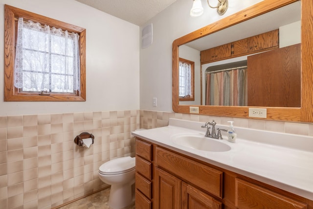1122 Andrew Dr NE, Lake Andrew Twp, MN 56273 - full bathroom with vanity, healthy amount of natural light, toilet, tile walls, and a shower with shower curtain