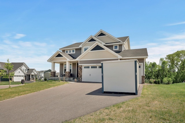 6674 Annabelle Ct, Corcoran, MN 55340 - craftsman inspired home featuring stone siding, driveway, a front yard, and a shingled roof