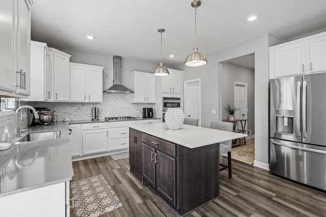 6674 Annabelle Ct, Corcoran, MN 55340 - kitchen with stainless steel appliances, wall chimney exhaust hood, a sink, white cabinetry, and recessed lighting