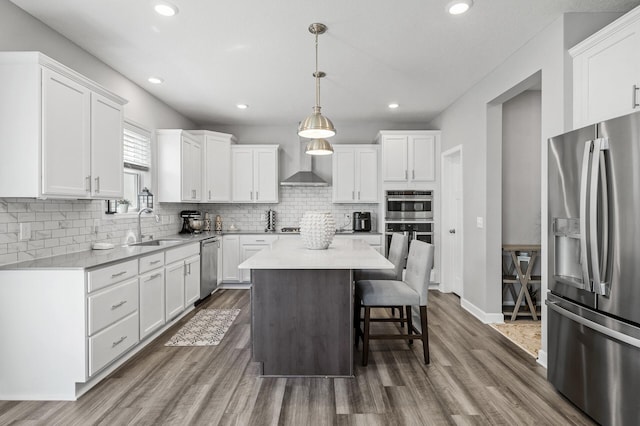 6674 Annabelle Ct, Corcoran, MN 55340 - kitchen featuring stainless steel appliances, a sink, white cabinets, dark wood-style flooring, and recessed lighting