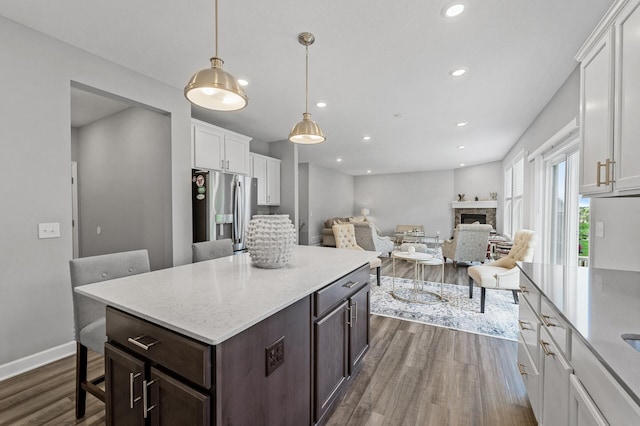 6674 Annabelle Ct, Corcoran, MN 55340 - kitchen with stainless steel refrigerator with ice dispenser, dark wood finished floors, white cabinetry, dark brown cabinetry, and recessed lighting