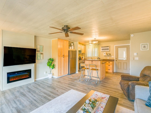 living area with wood ceiling, a ceiling fan, a wall mounted air conditioner, and light wood-type flooring