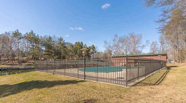 pool with a lawn and fence
