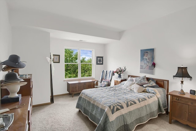 carpeted bedroom featuring visible vents and baseboards