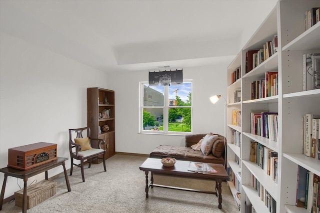 living area with baseboards and carpet floors