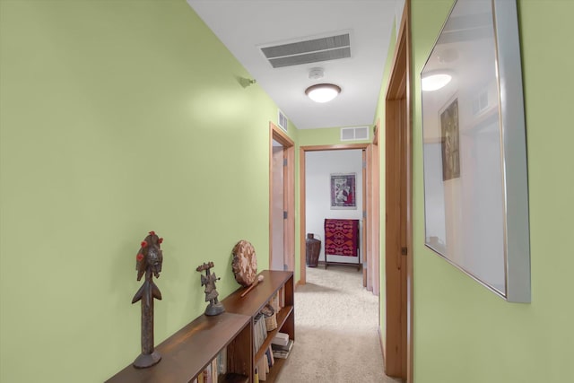 hallway featuring light carpet and visible vents