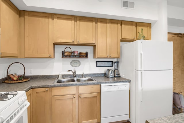 kitchen with a sink, dark countertops, visible vents, white appliances, and light brown cabinets