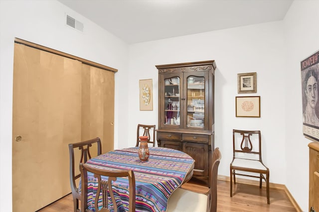 dining space with visible vents and light wood finished floors