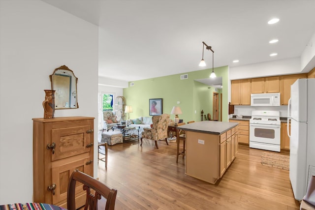 kitchen with a center island, light wood-type flooring, open floor plan, visible vents, and white appliances
