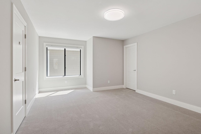 unfurnished bedroom featuring carpet floors and baseboards