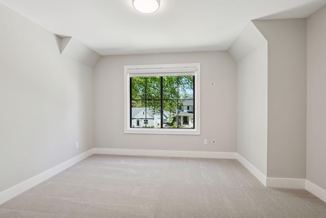 carpeted spare room with baseboards
