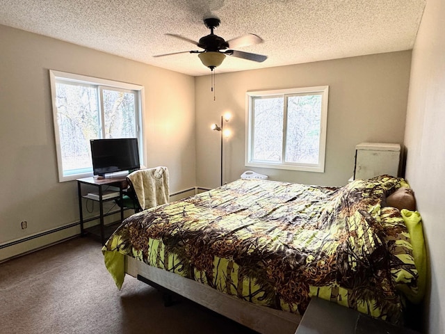 carpeted bedroom with baseboard heating, a textured ceiling, and ceiling fan