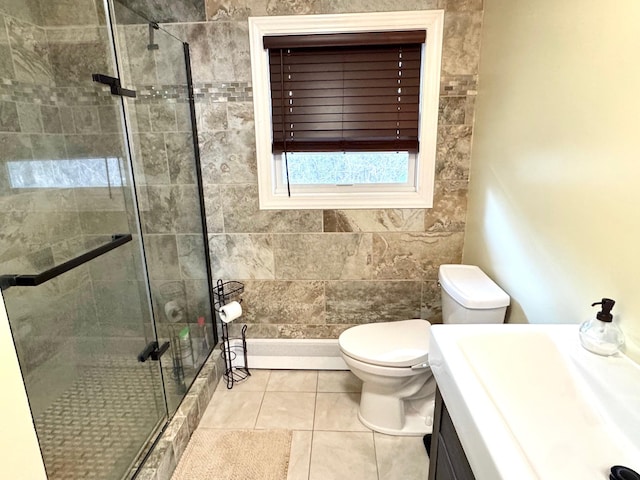 full bath featuring tile patterned floors, vanity, a shower stall, and toilet