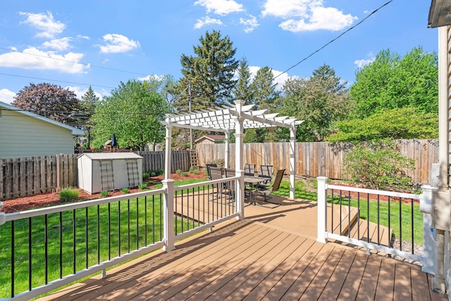 wooden deck featuring a shed, a pergola, outdoor dining area, and an outbuilding