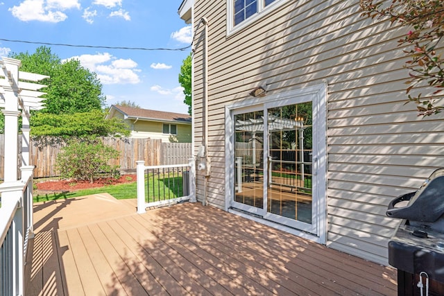 wooden terrace featuring fence