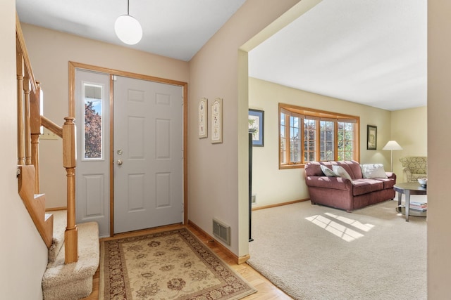 entryway featuring stairway and baseboards