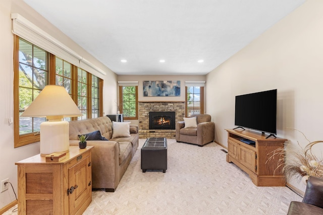 living area with baseboards, light carpet, a brick fireplace, and recessed lighting