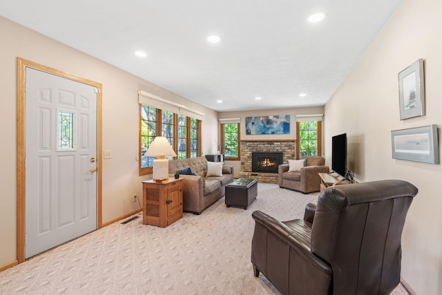 living room with recessed lighting, light carpet, a brick fireplace, and baseboards