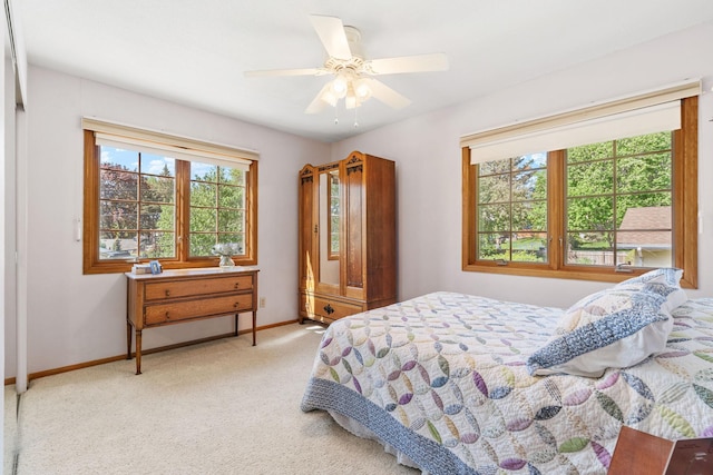 carpeted bedroom with baseboards and ceiling fan