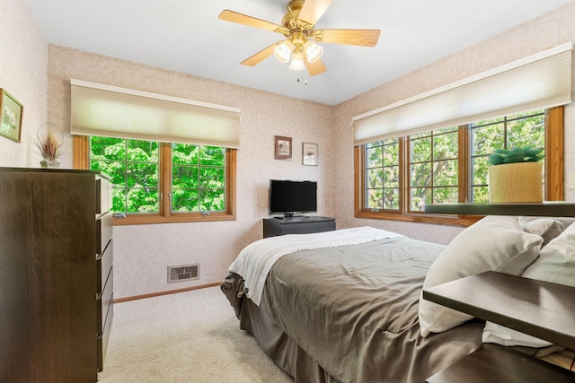 bedroom with carpet flooring, baseboards, and ceiling fan