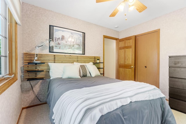 carpeted bedroom featuring a closet and ceiling fan