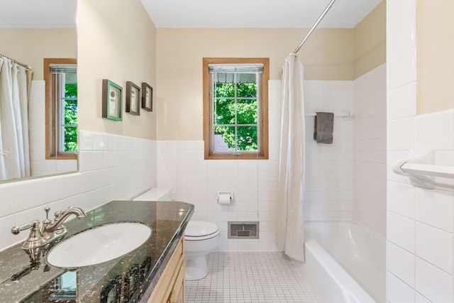 bathroom featuring tile walls, toilet, tile patterned flooring, vanity, and shower / bathtub combination with curtain