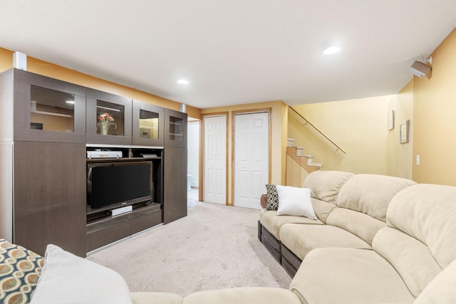 living area featuring carpet floors, stairway, and recessed lighting