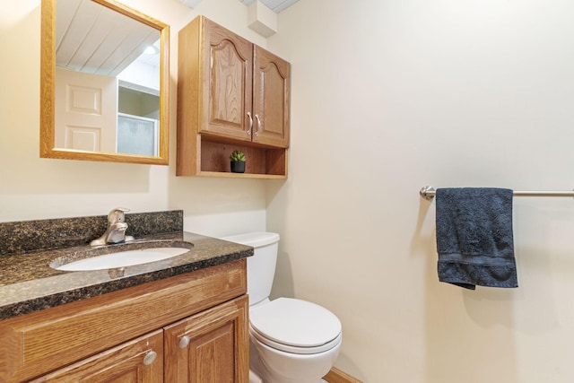 bathroom featuring toilet and vanity