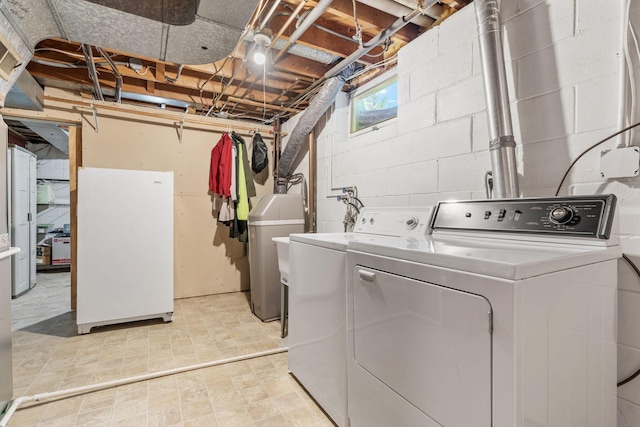 clothes washing area featuring independent washer and dryer