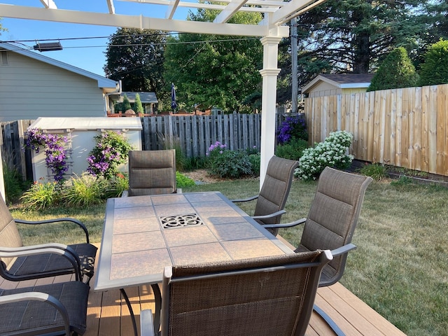 deck featuring outdoor dining space, fence, and a pergola