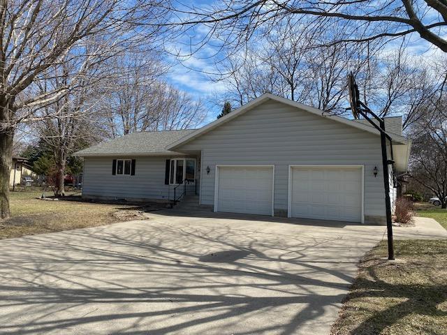 2509 6th St SW, Willmar, MN 56201 - view of front of house featuring a garage, a chimney, and concrete driveway