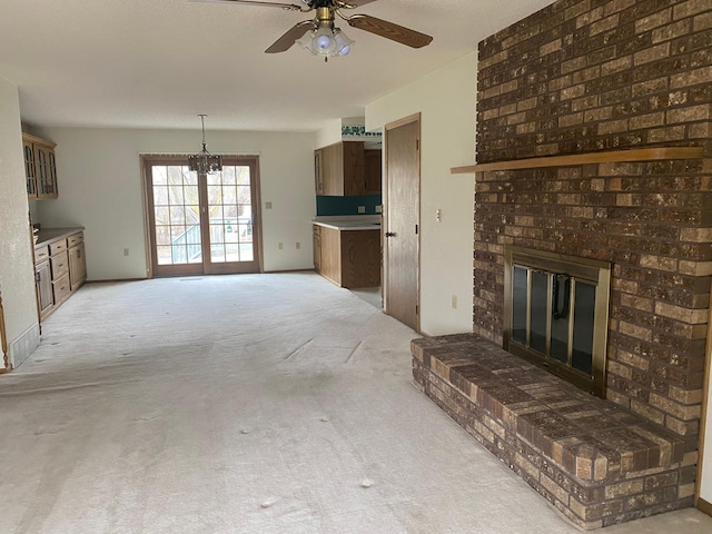 2509 6th St SW, Willmar, MN 56201 - unfurnished living room featuring a brick fireplace, light colored carpet, and ceiling fan with notable chandelier