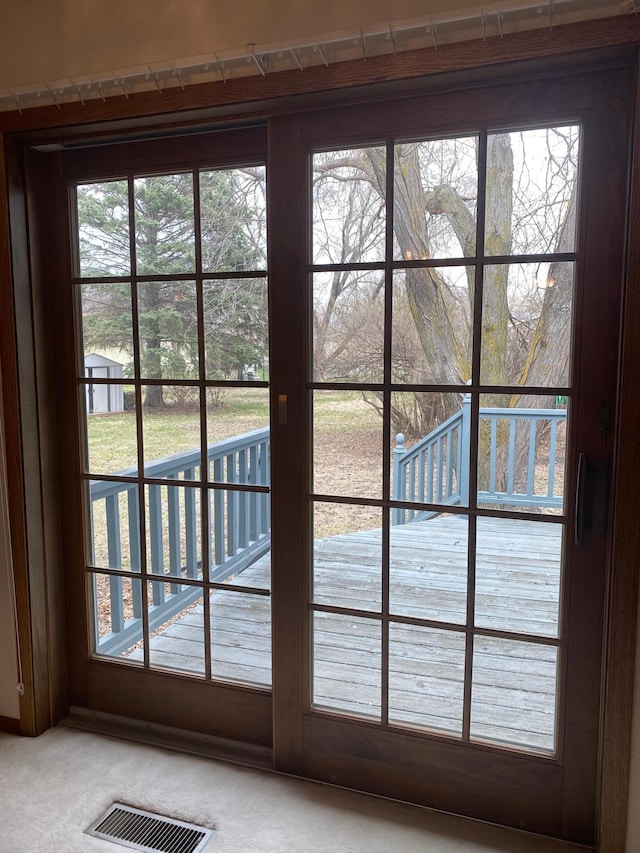2509 6th St SW, Willmar, MN 56201 - doorway to outside featuring carpet flooring and visible vents