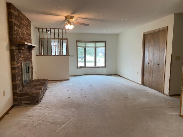 2509 6th St SW, Willmar, MN 56201 - unfurnished living room featuring baseboards, carpet flooring, a fireplace, and ceiling fan