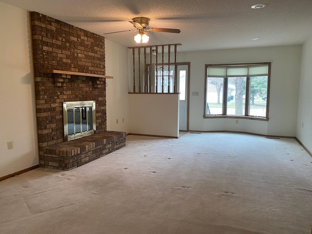 2509 6th St SW, Willmar, MN 56201 - unfurnished living room with a brick fireplace, a ceiling fan, baseboards, a textured ceiling, and carpet flooring