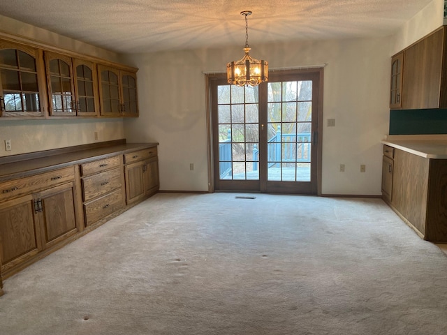 2509 6th St SW, Willmar, MN 56201 - unfurnished dining area featuring visible vents, light carpet, baseboards, a textured ceiling, and a notable chandelier