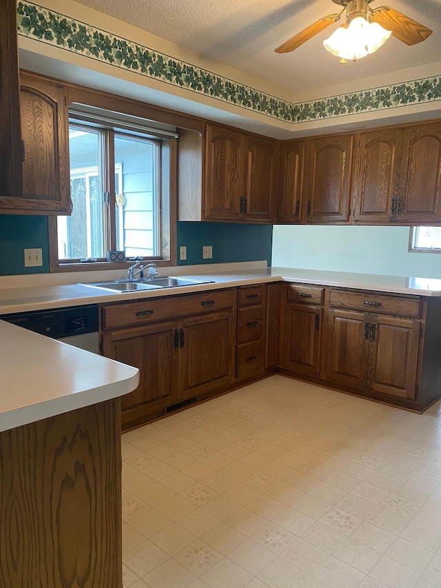 2509 6th St SW, Willmar, MN 56201 - kitchen with a sink, a ceiling fan, dishwasher, light floors, and light countertops