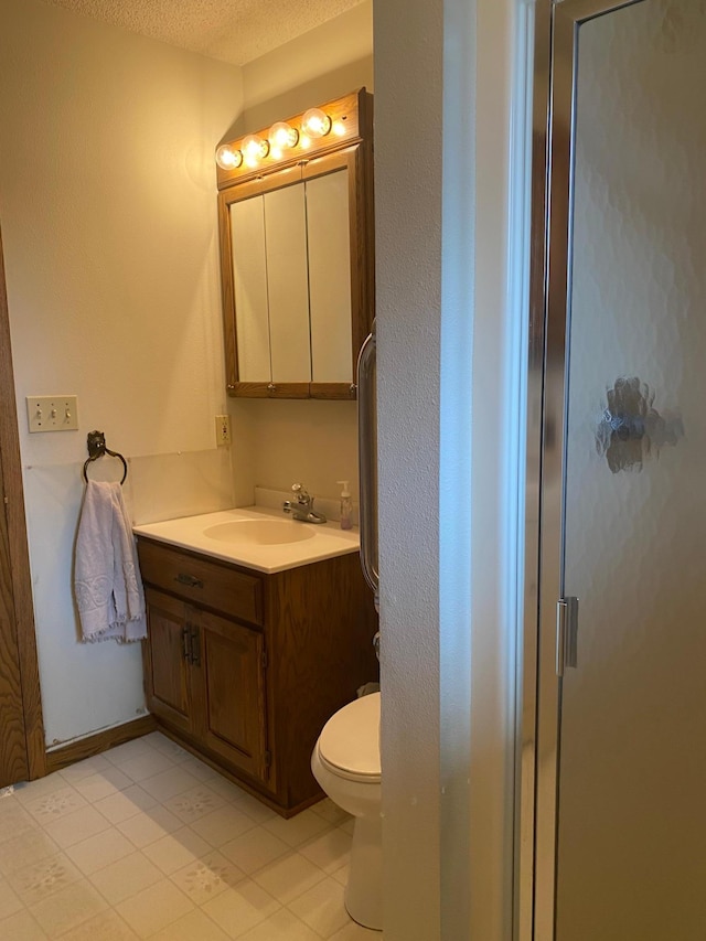 2509 6th St SW, Willmar, MN 56201 - bathroom featuring a shower stall, a textured ceiling, toilet, and vanity