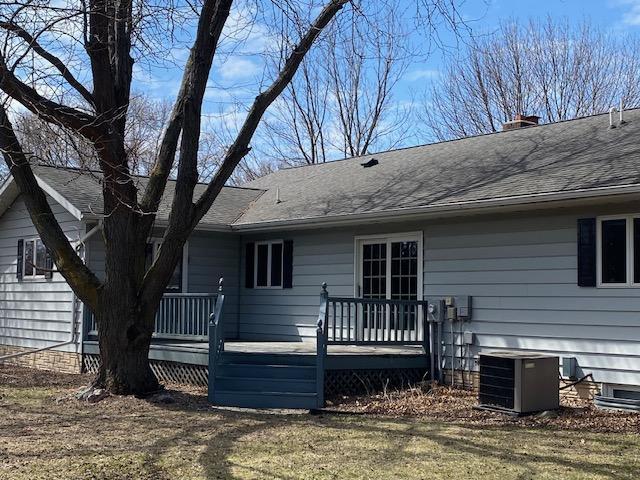 2509 6th St SW, Willmar, MN 56201 - back of property with central AC unit, roof with shingles, and a deck