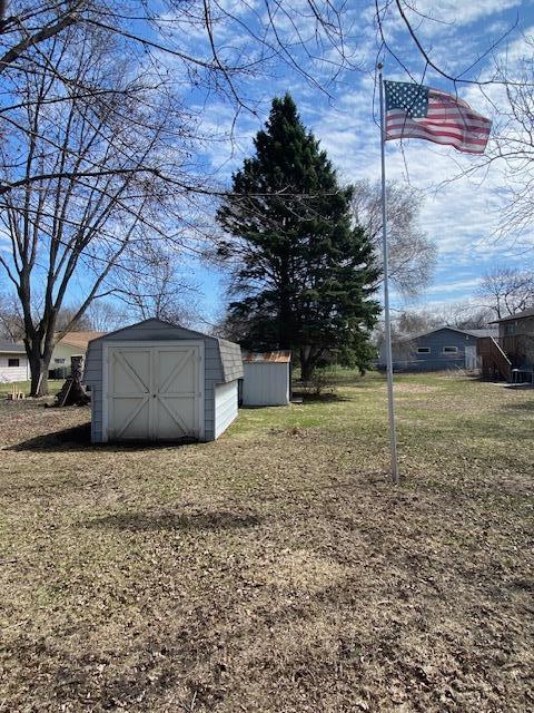 2509 6th St SW, Willmar, MN 56201 - view of yard featuring a storage unit and an outdoor structure