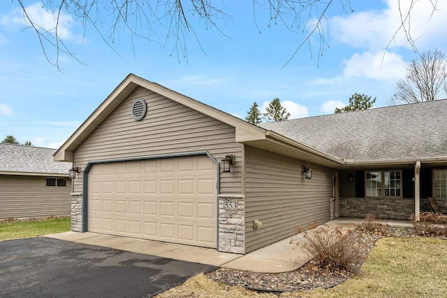 553 Cedar Ct, Taylors Falls, MN 55084 - exterior space with stone siding, a shingled roof, and a garage