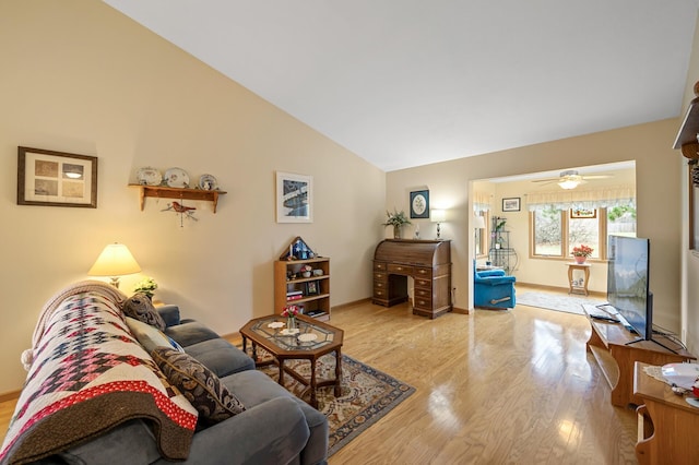 553 Cedar Ct, Taylors Falls, MN 55084 - living room with lofted ceiling, a ceiling fan, wood finished floors, and baseboards